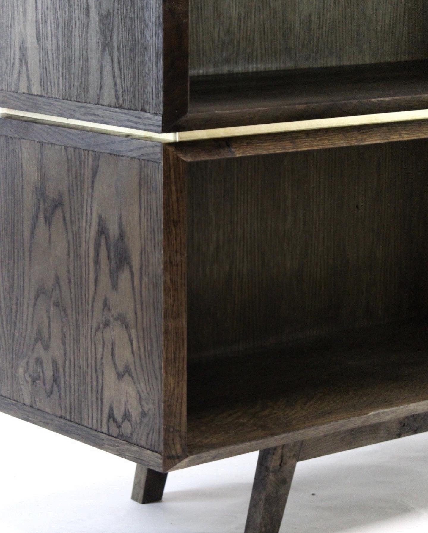Burnt oak and brass bookcase.